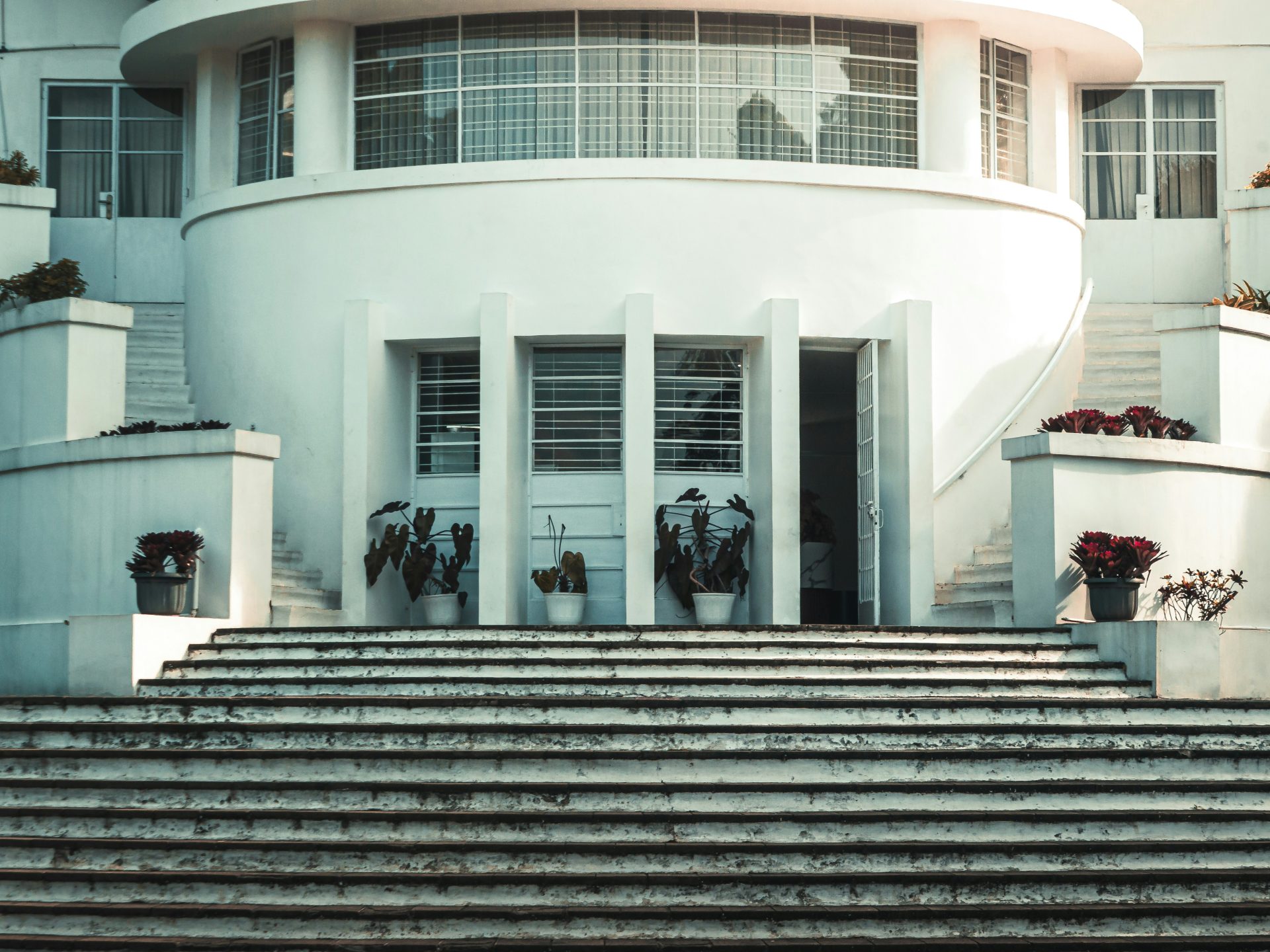 White building with curved facade and wide stairs